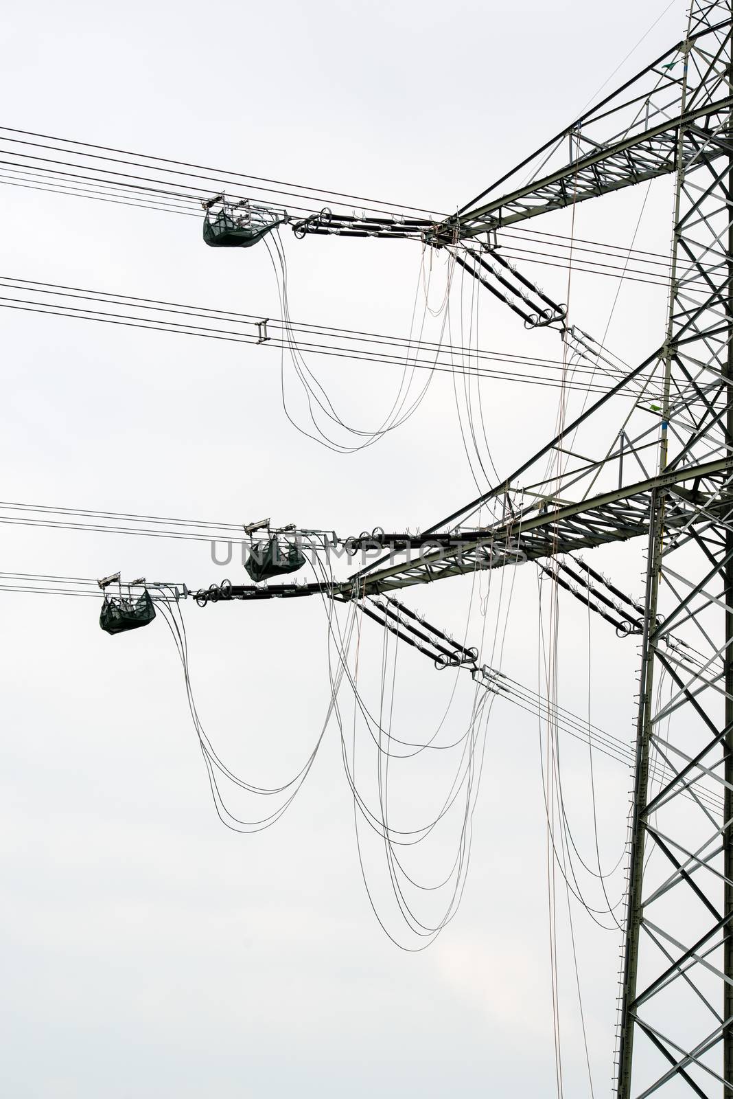 high voltage power pole construction works - cables being mounted