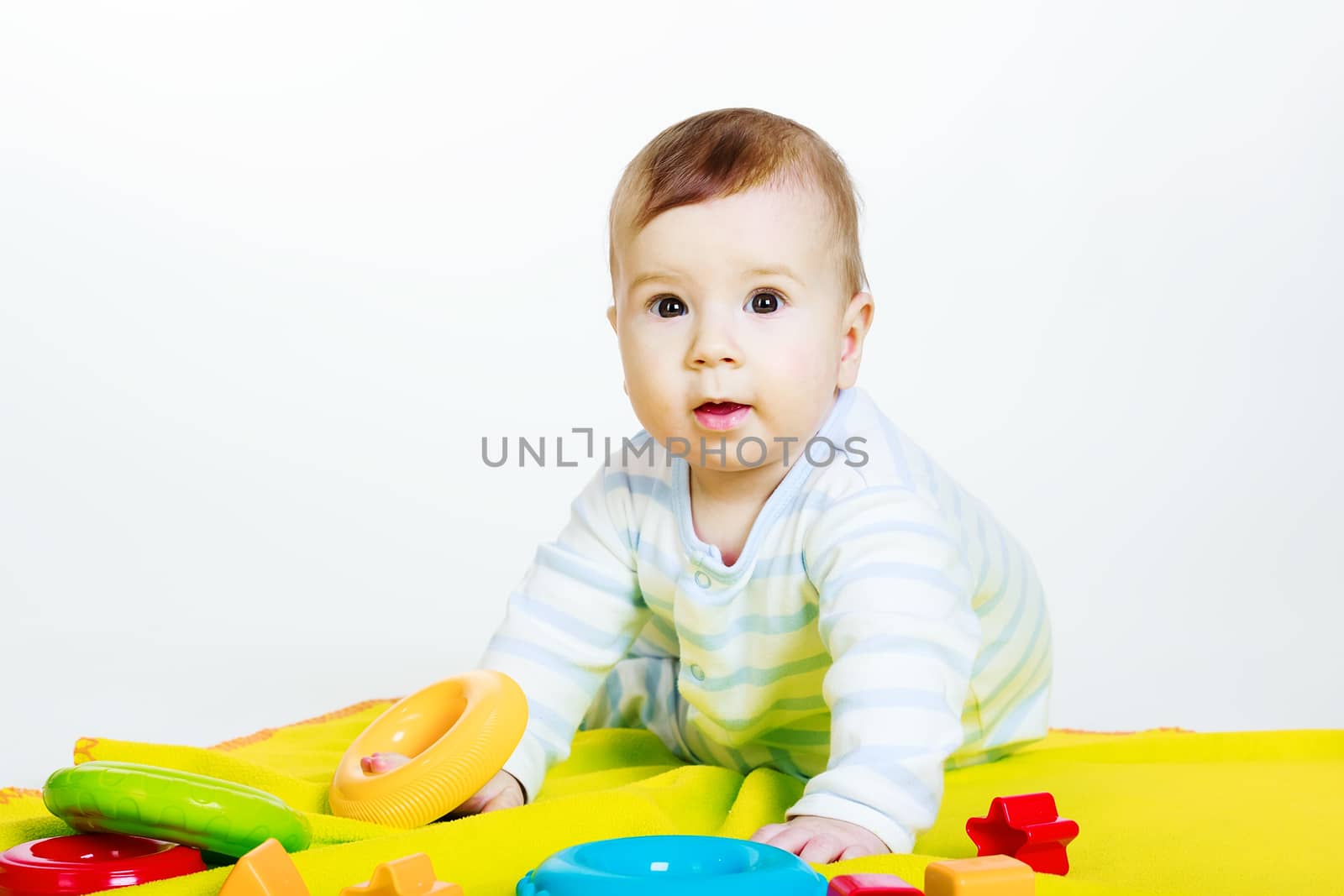 Studio photography. Little baby boy with toys