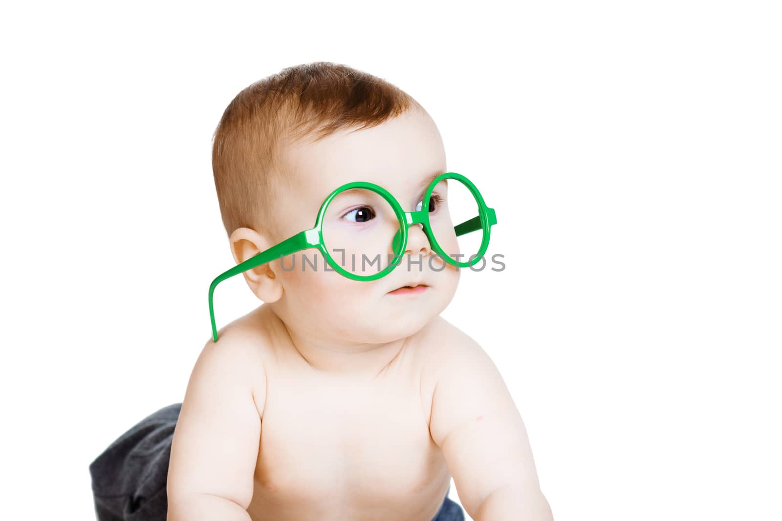 Studio photography. Little baby boy in the big funny glasses. isolated on white background