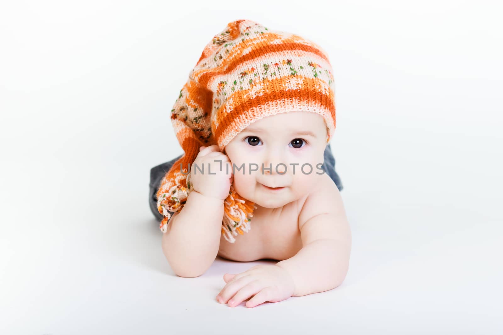 Studio photography. Little baby boy in a knitted hat posing