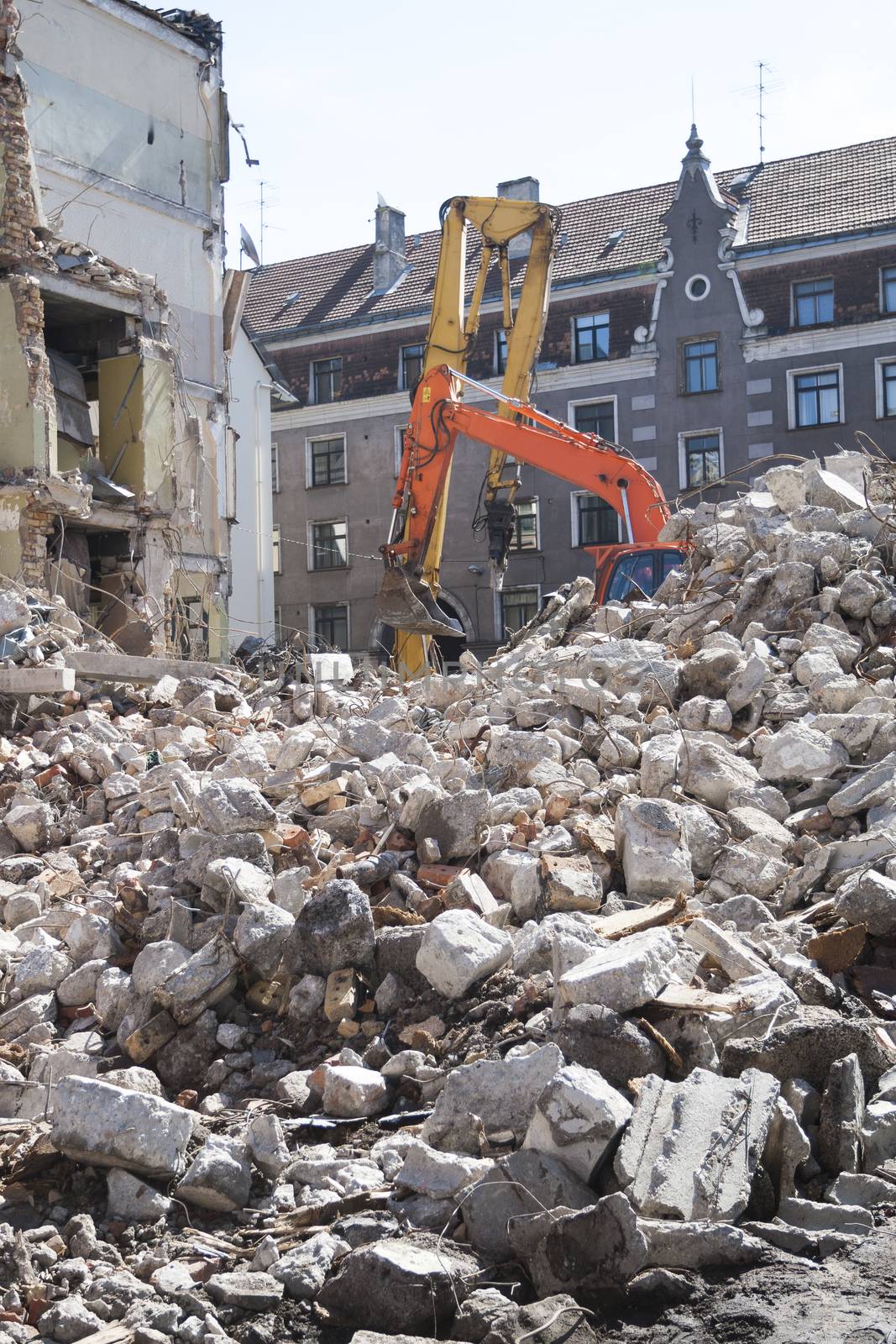 Demolition of an old building with heavy machinery for new construction