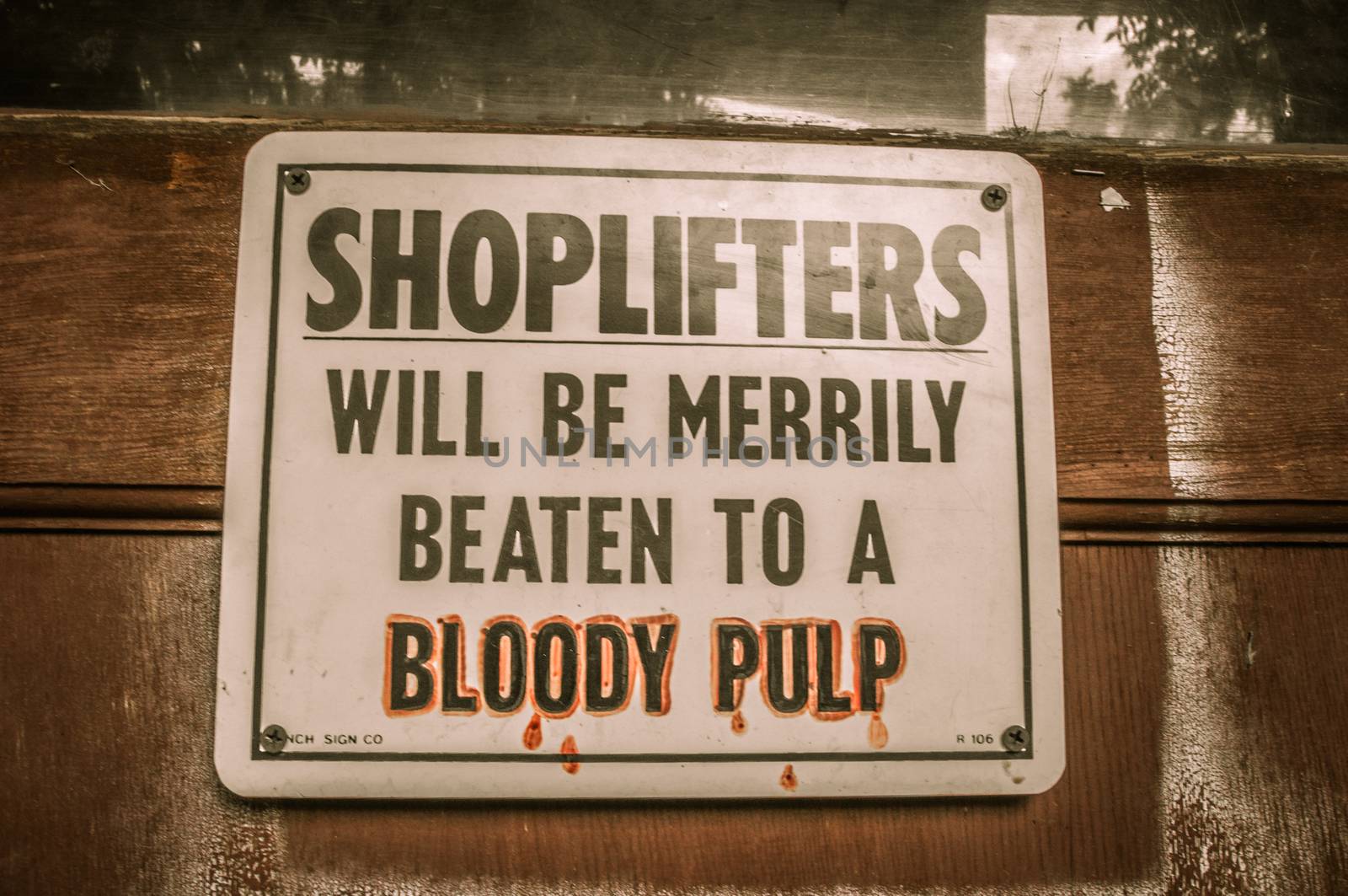 Shoplifters sign in Jerome Arizona Ghost Town mine and old cars
