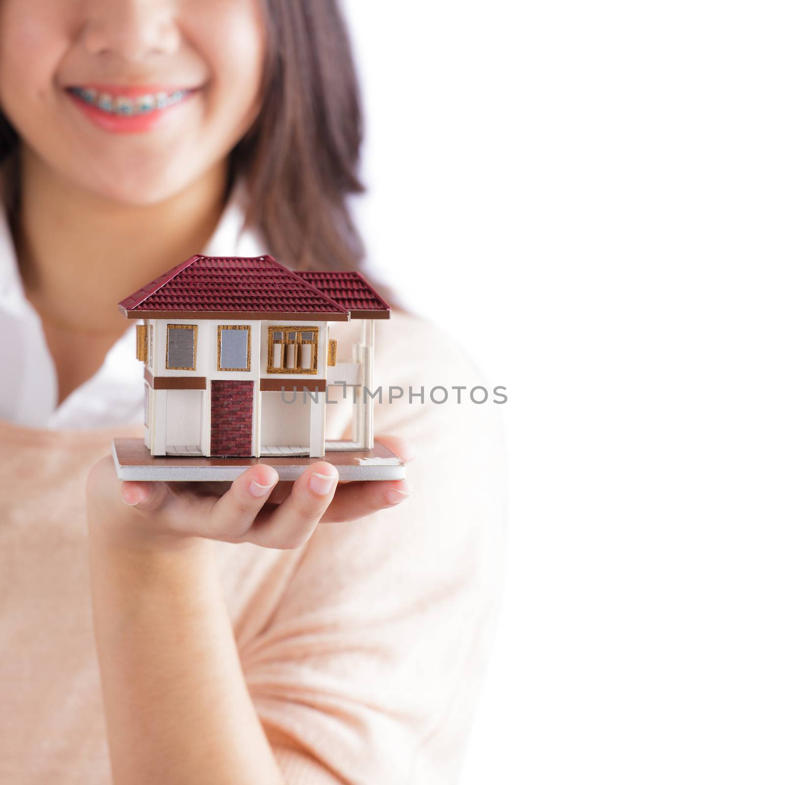 Woman holding little house