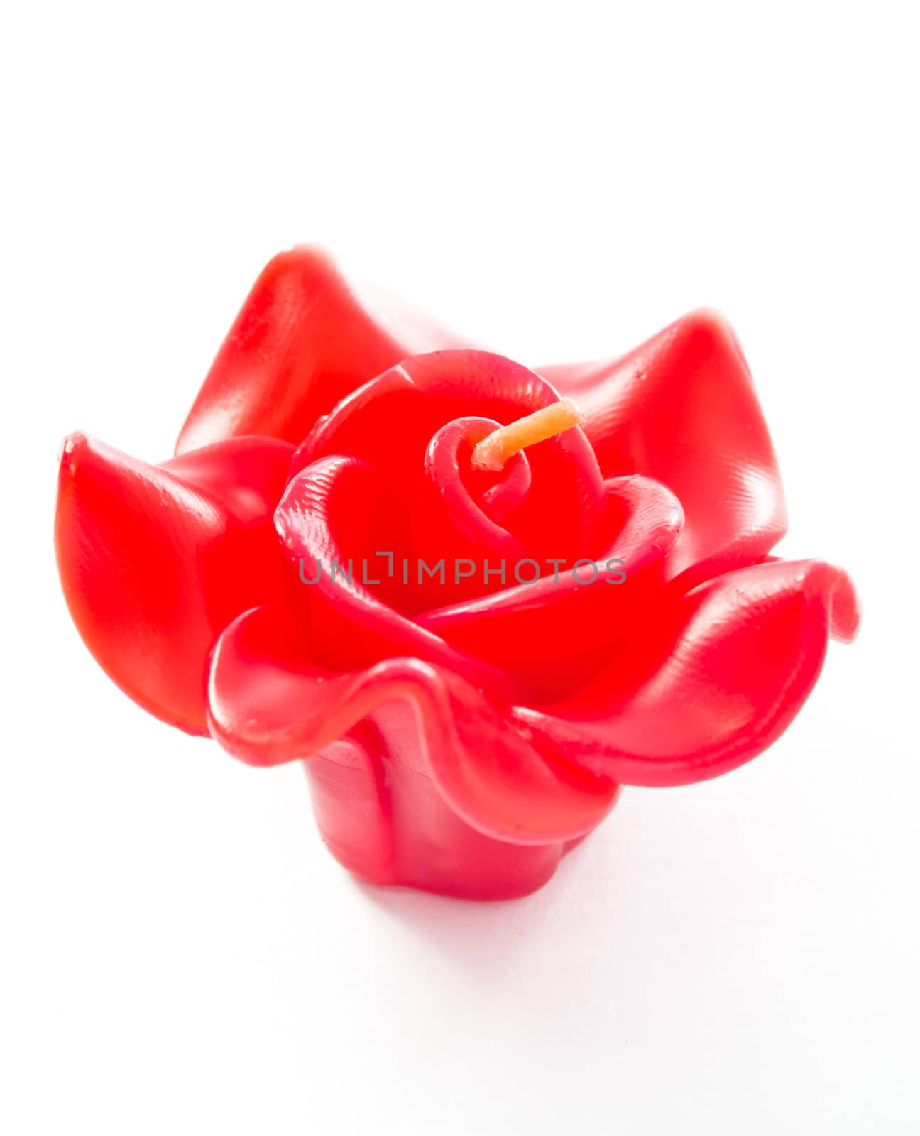 Red rose candle isolated on white background