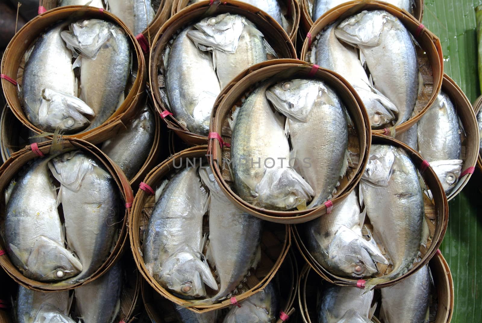 Mackerel fish in bamboo basket at market, Thailand by think4photop