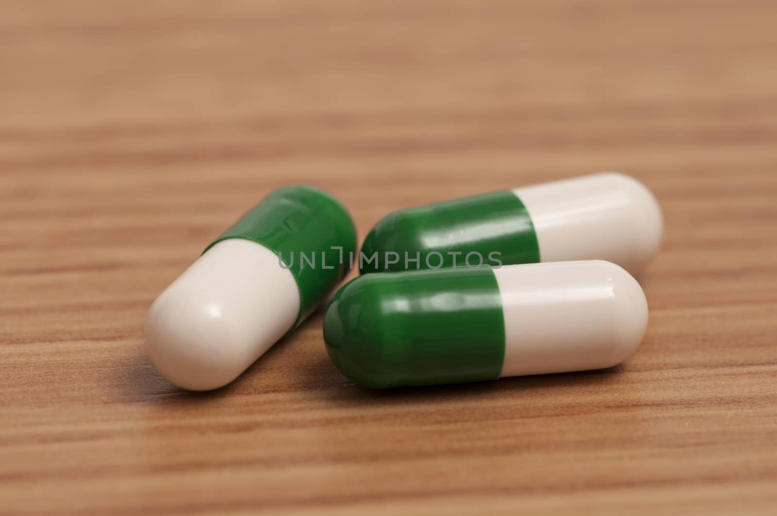 Three capsules or pills on the table