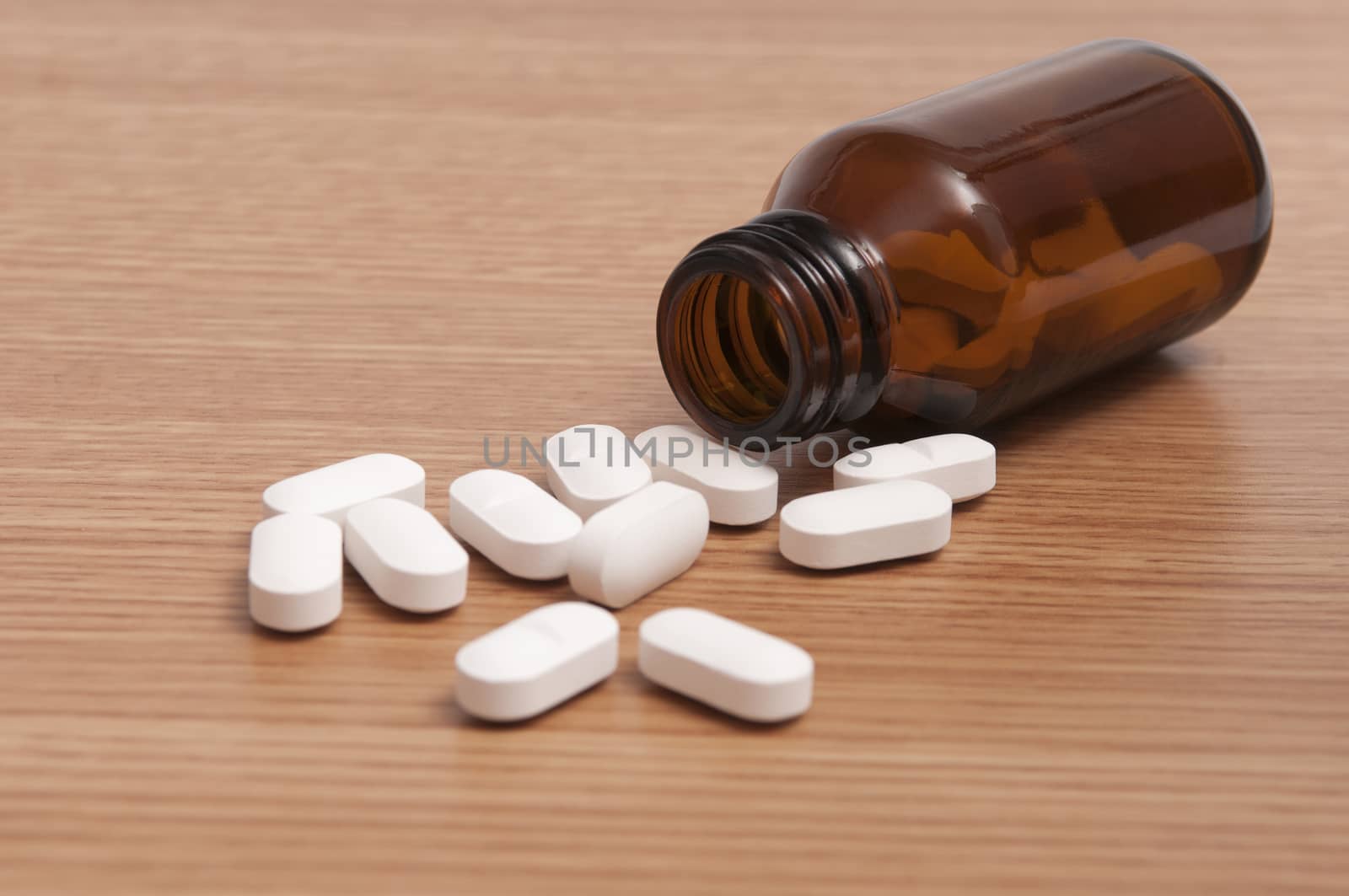 Some capsules and pills in a bottle on the table