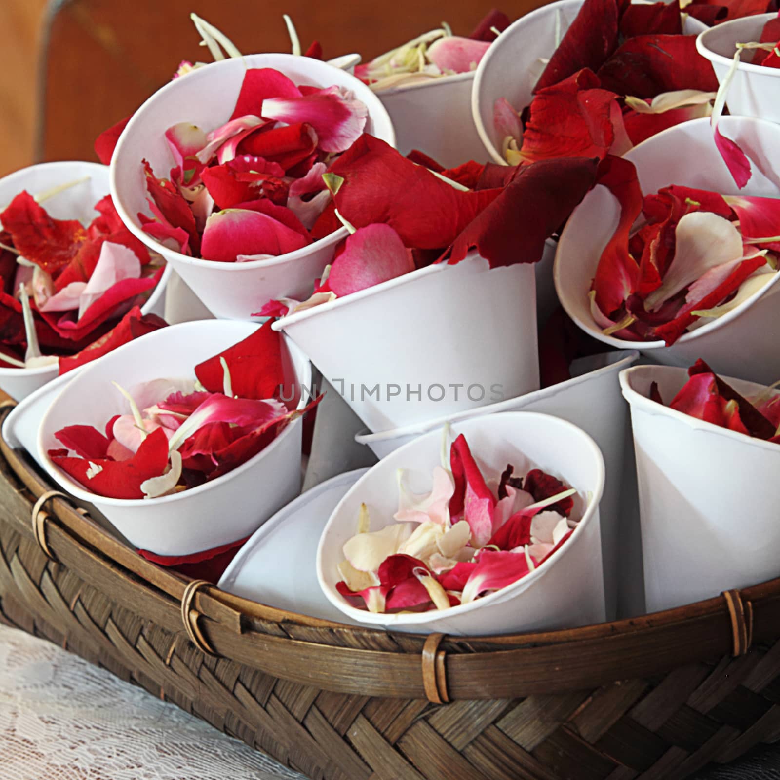 Rose petals in cup for scattering in wedding