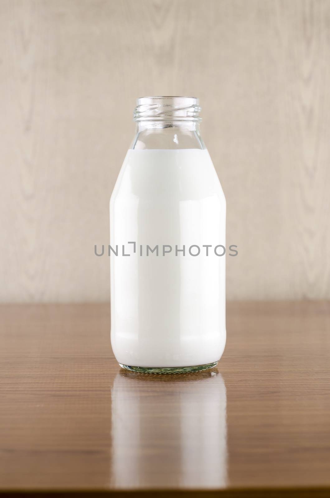 milk in a glass of bottle on wood table background