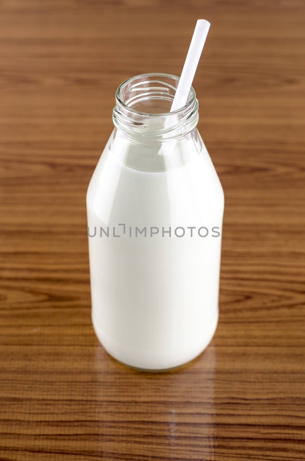 milk with straw in a glass of bottle by ammza12