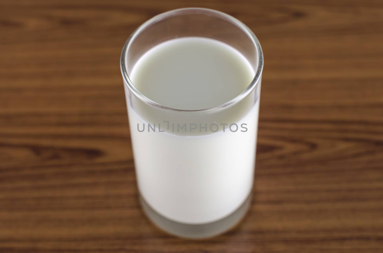 milk in a glass on wood background
