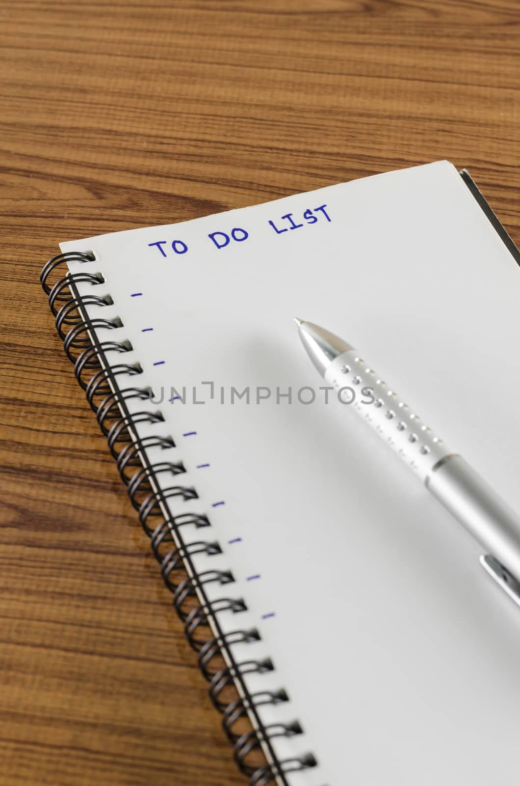 notebook and pen with word to do list on wood background