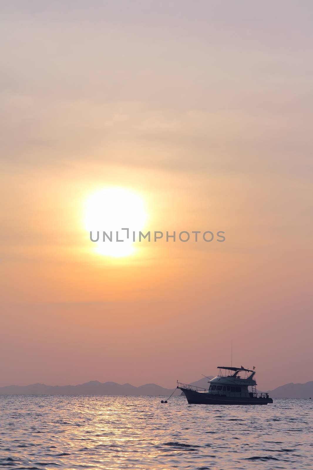Sailing yaht in open sea on beautiful sunset sky background