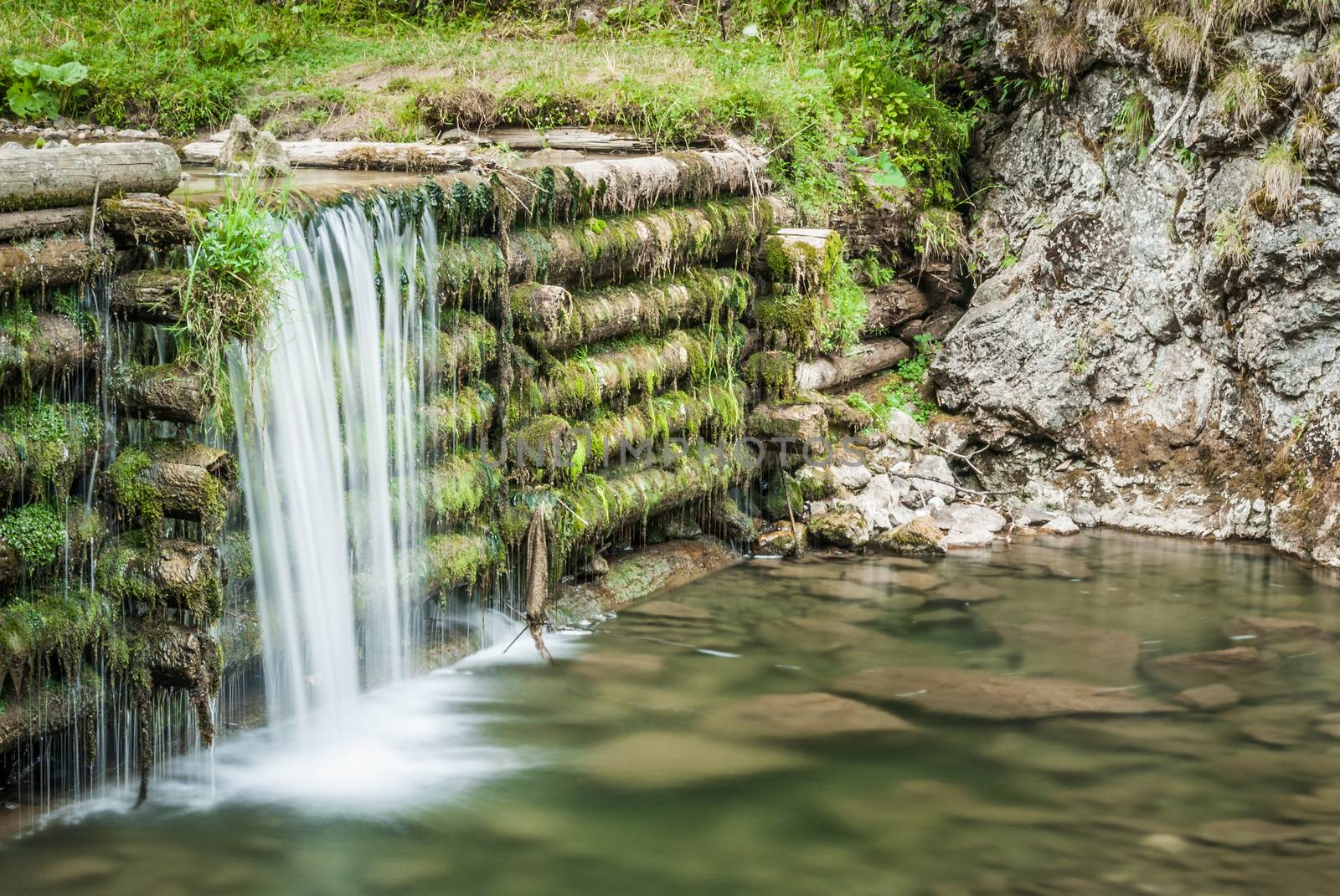 creek and man made waterfall in the forest