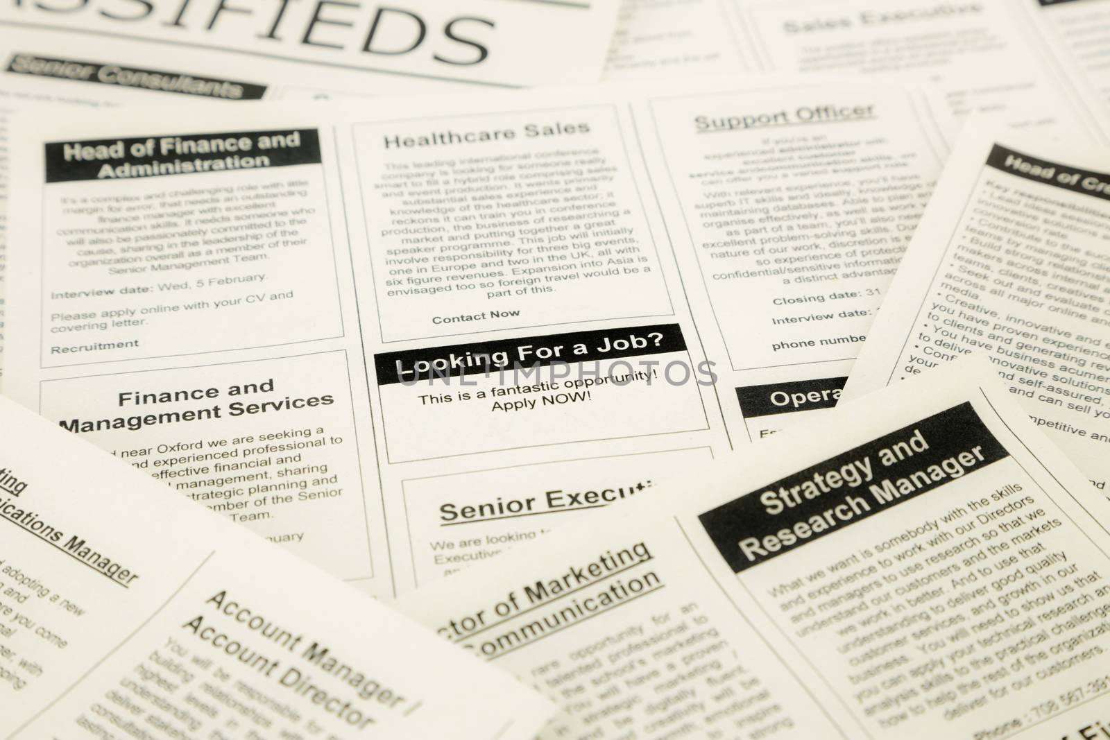 newspaper with advertisements and classifieds ads for vacancy, search for jobs