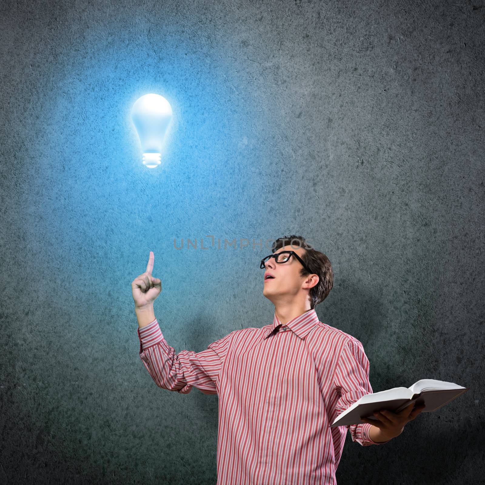 young man holding a book in front of him, raised his hand, the idea