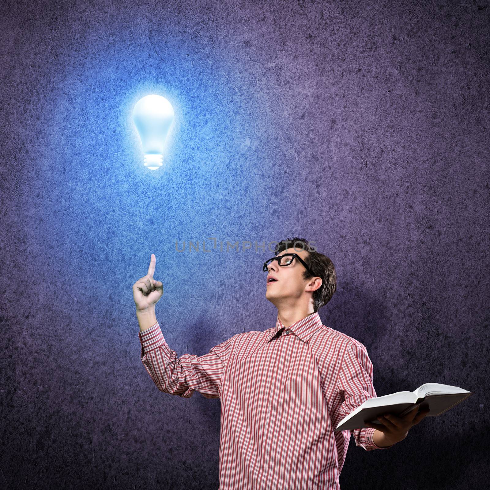 young man holding a book in front of him, raised his hand, the idea