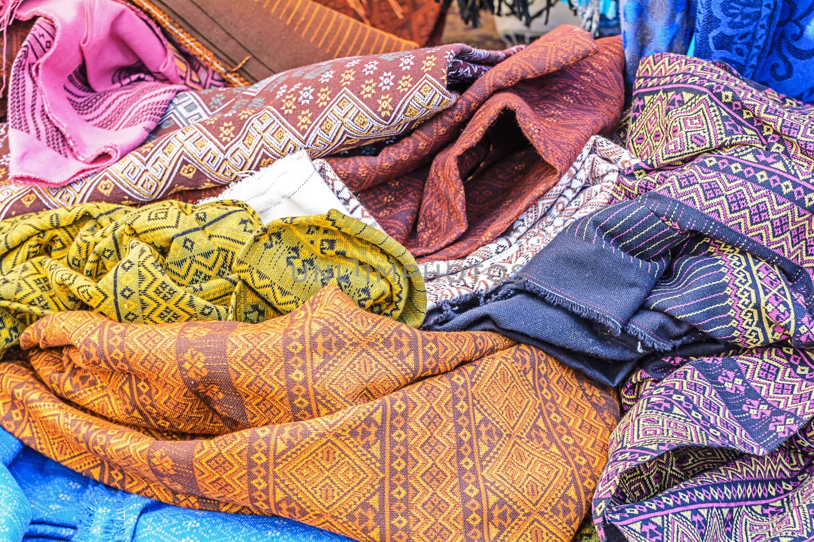 stack of traditional sarong by NuwatPhoto