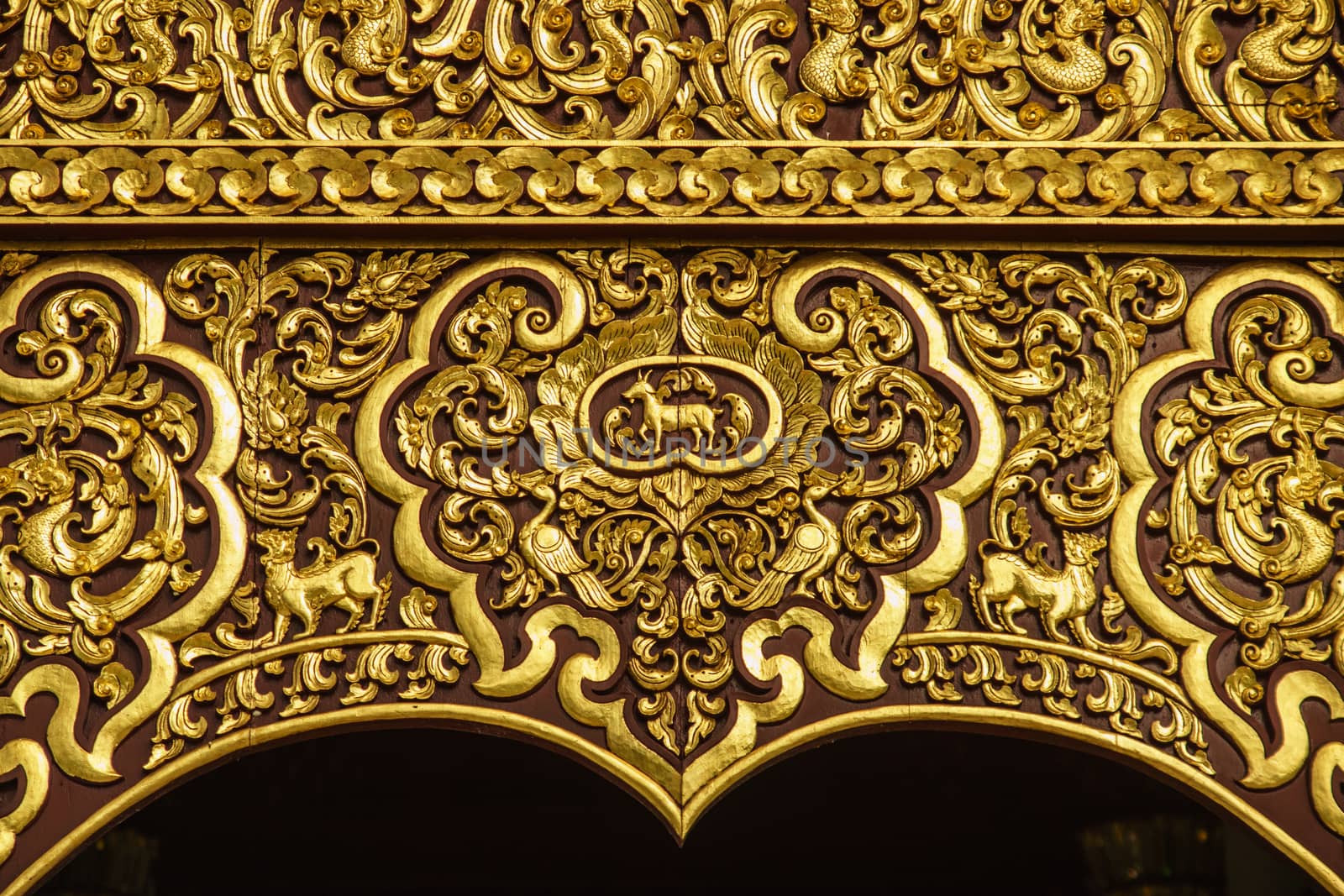 detail of wood carving with thai pattern on natural wood plate for decorated temple,Thailand