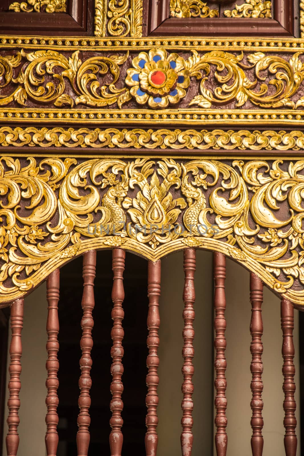 detail of wood carving with thai pattern on natural wood plate for decorated temple,Thailand