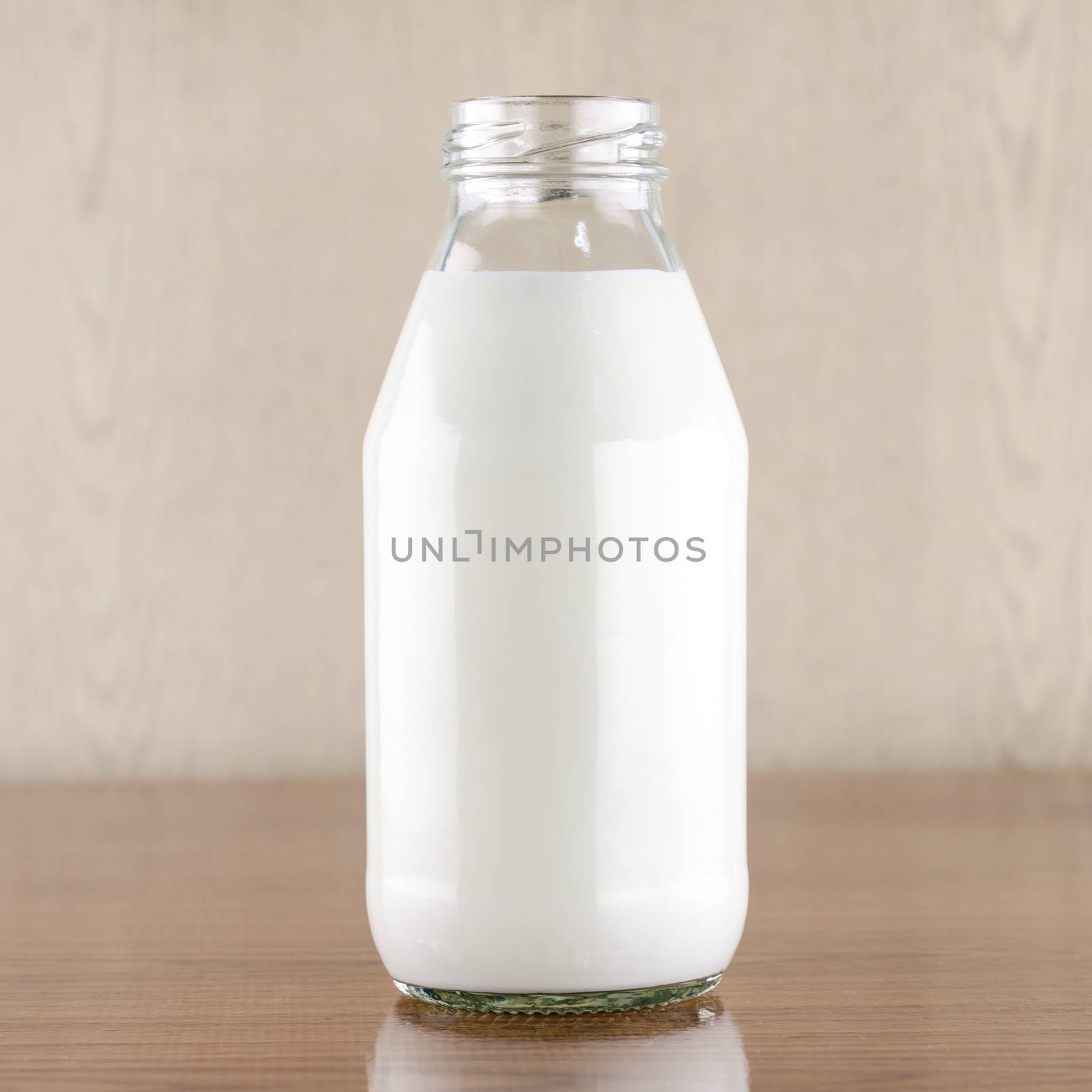 milk in a glass of bottle on wood table background