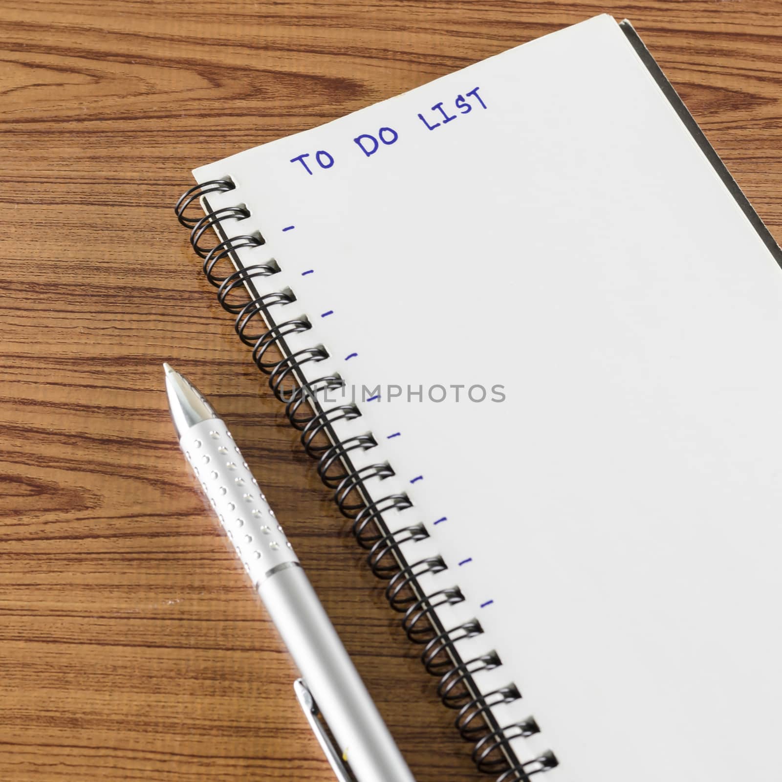 notebook and pen with word to do list on wood background