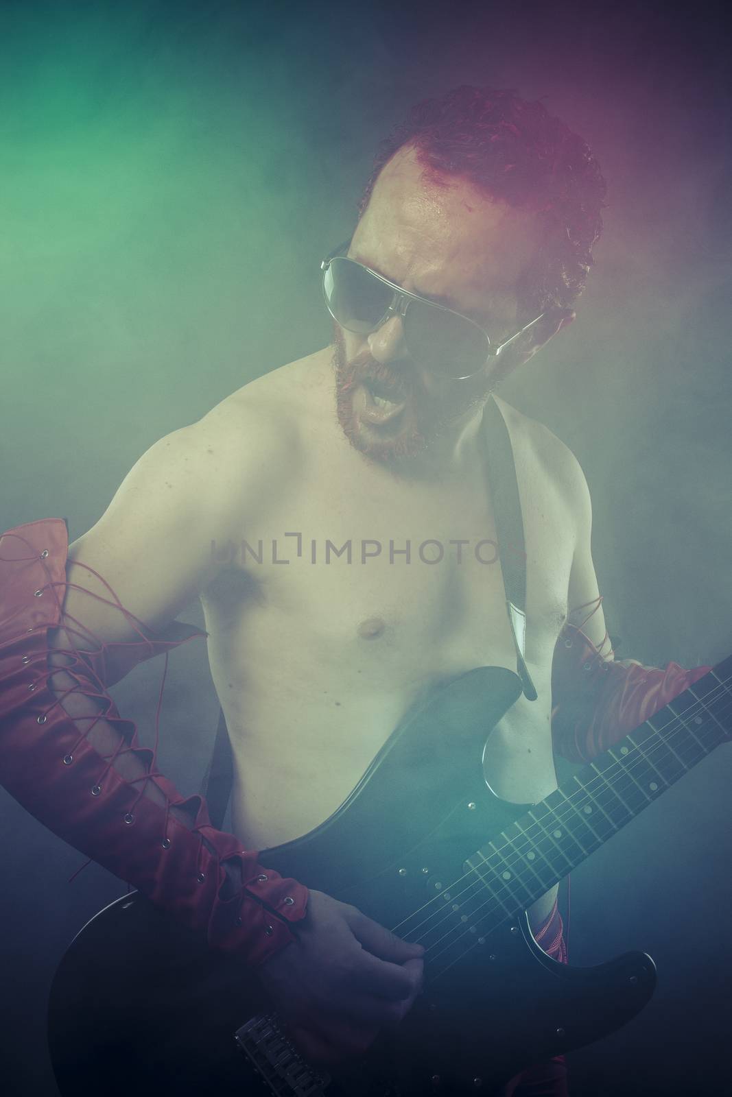 Play, rocker man with electric guitar in a rock concert by FernandoCortes