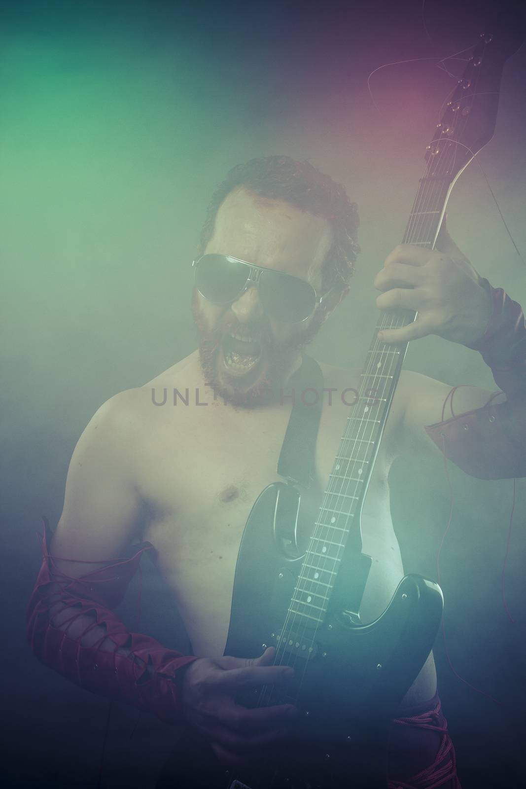 rocker man with electric guitar in a rock concert