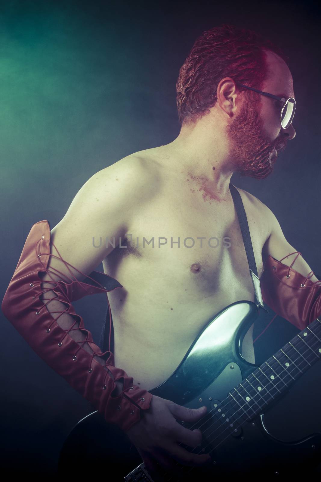 Metal, rocker man with electric guitar in a rock concert