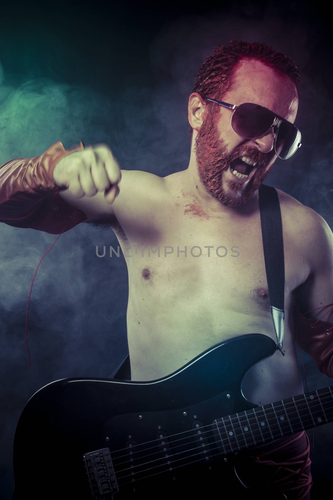 rocker man with electric guitar in a rock concert