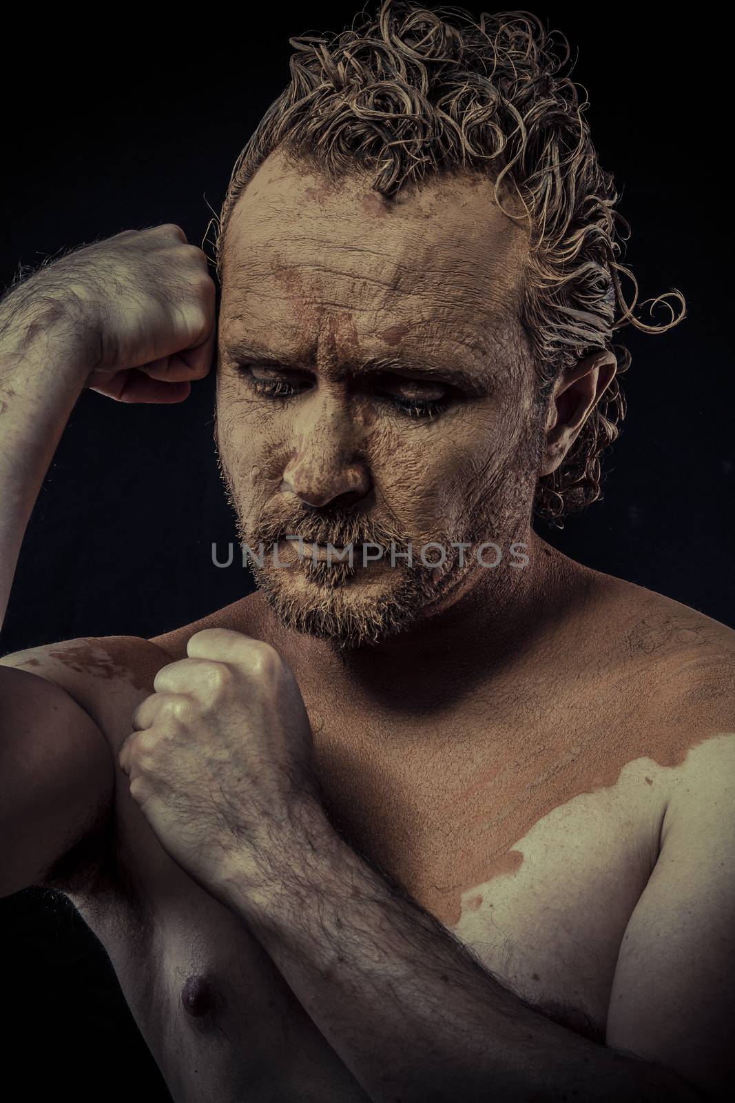 man with mud all over his body, naked, conceptual art