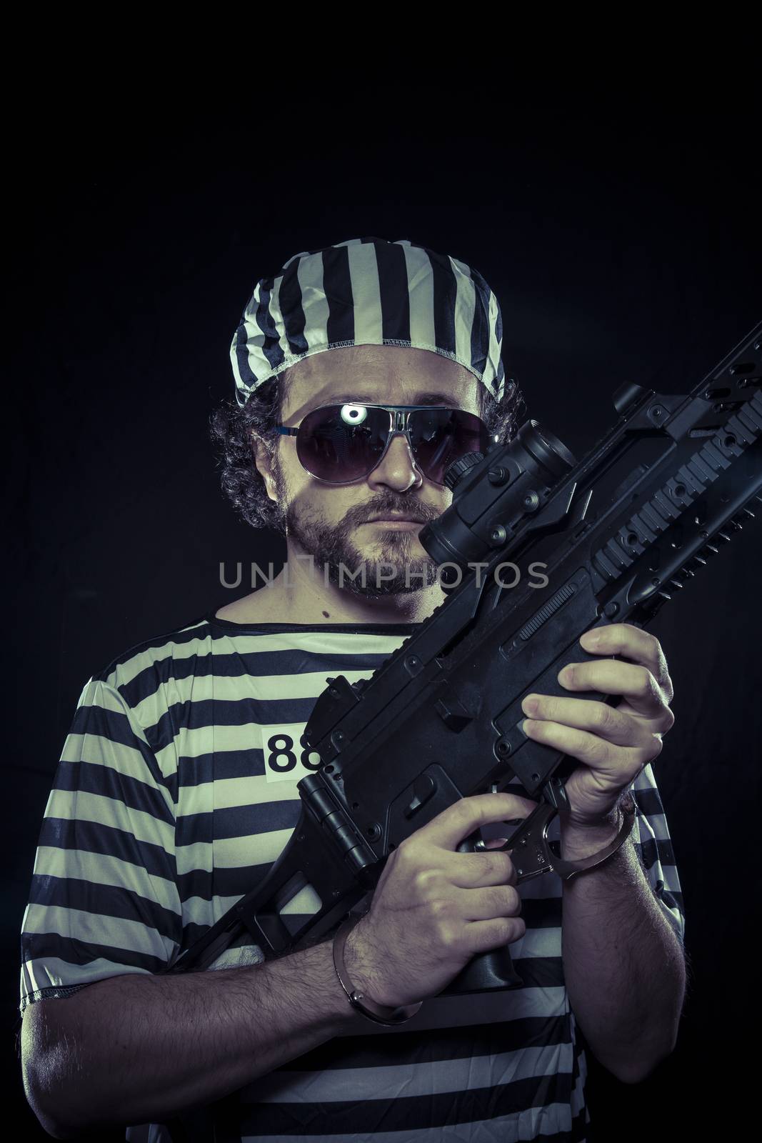 riot, prisoner in a prison with a machine gun