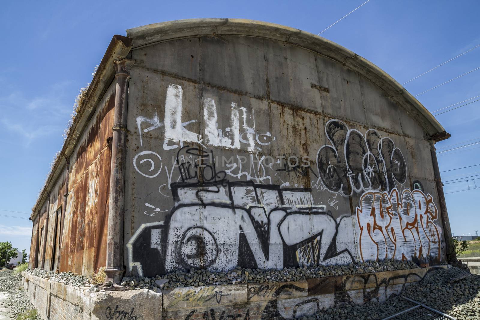 Grafitti, old abandoned train station, rusty iron walls