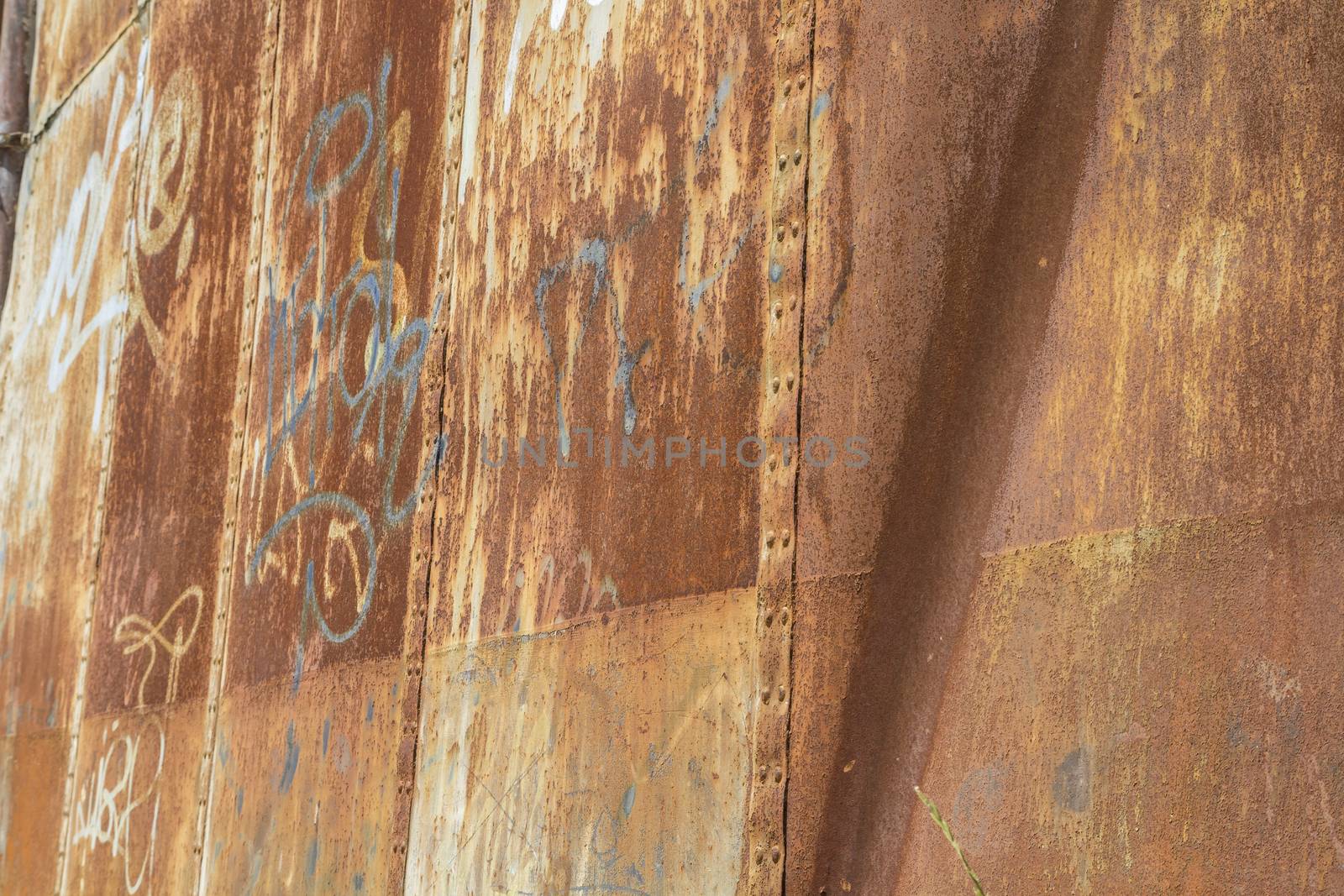 Grafitti, old abandoned train station, rusty iron walls
