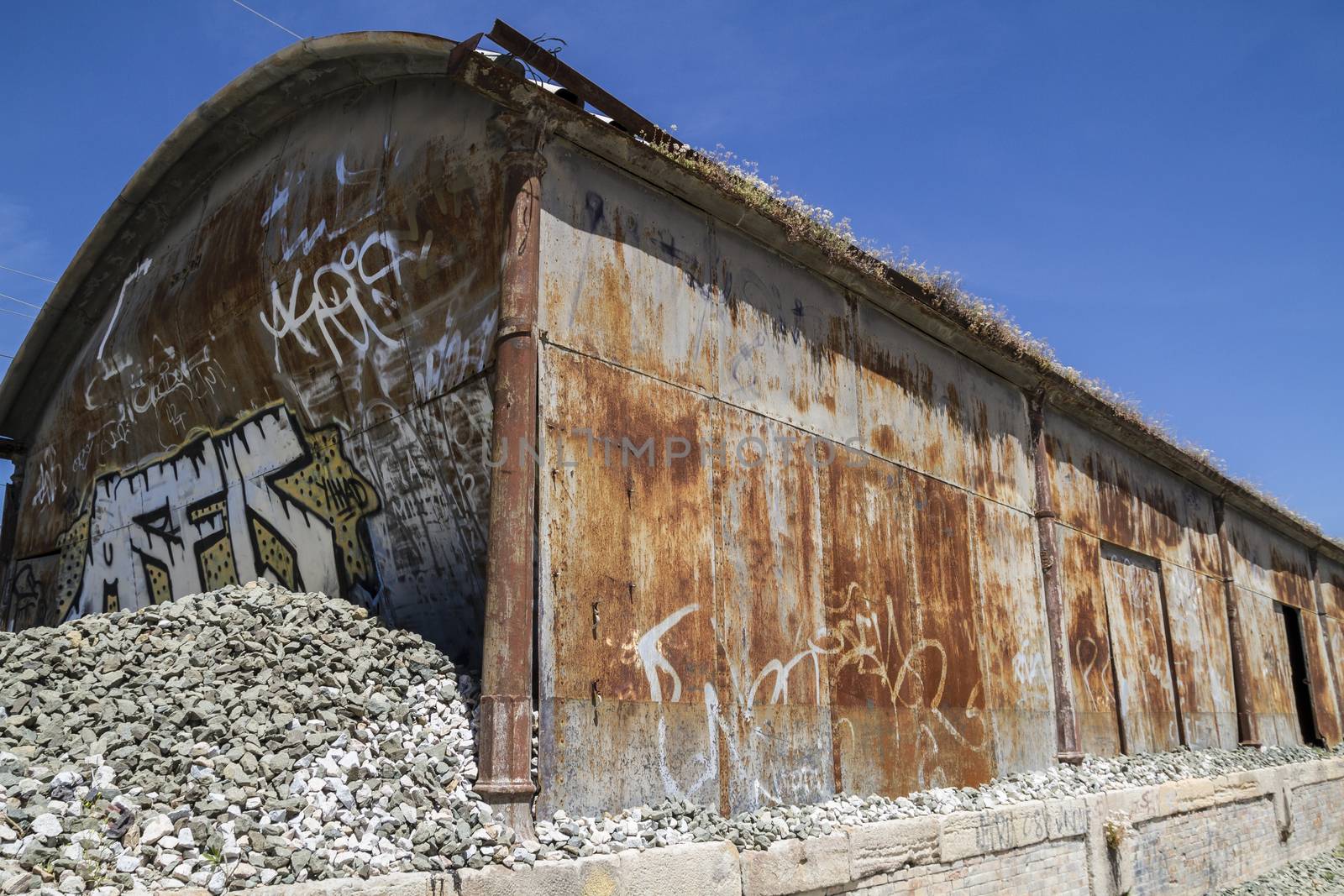 old abandoned train station, rusty iron walls