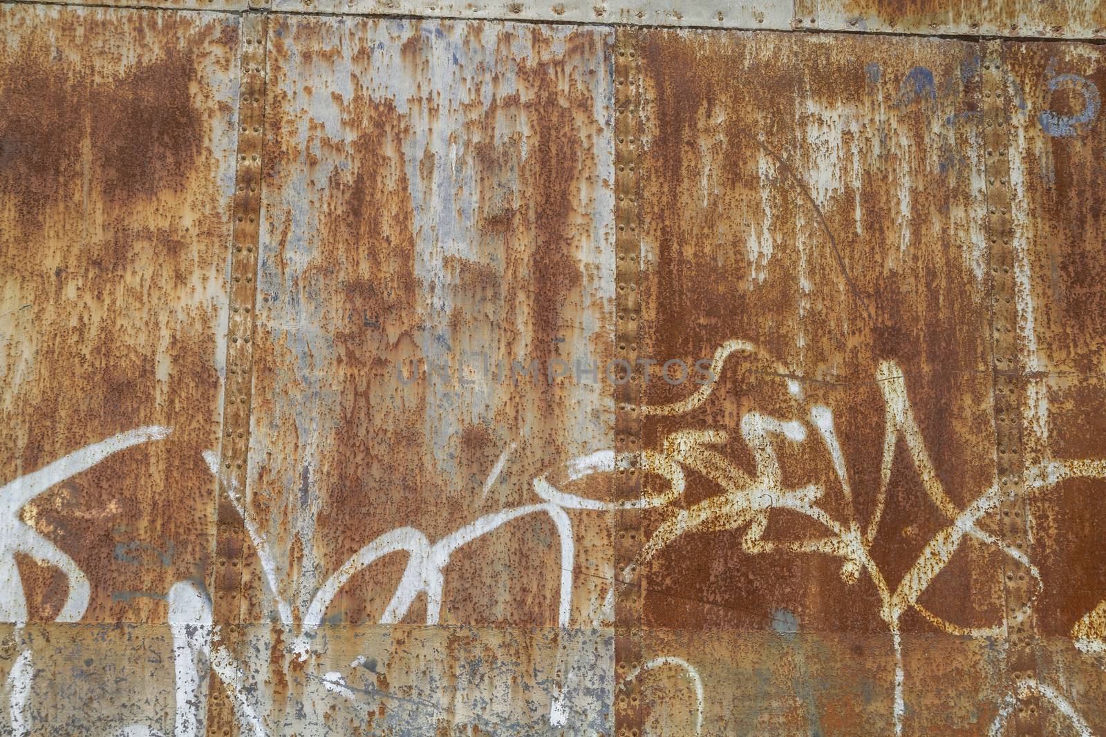 old abandoned train station, rusty iron walls, graffiti