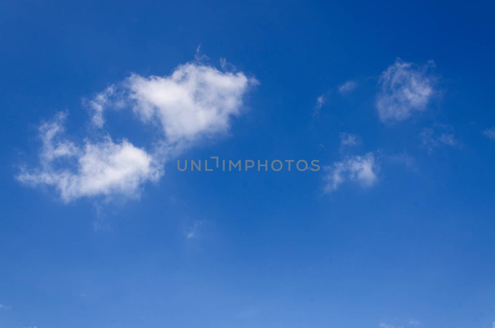 White clouds in blue sky by NuwatPhoto