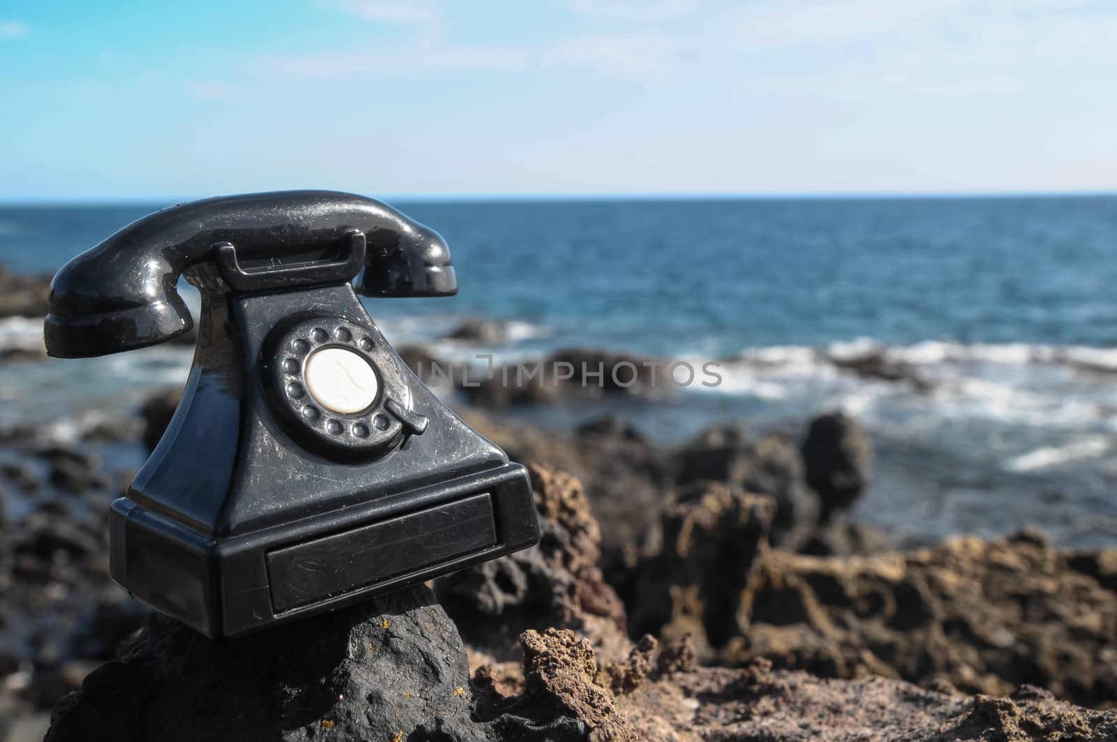 International Communications Vintage Telephone Toy on the Volcanic Rocks