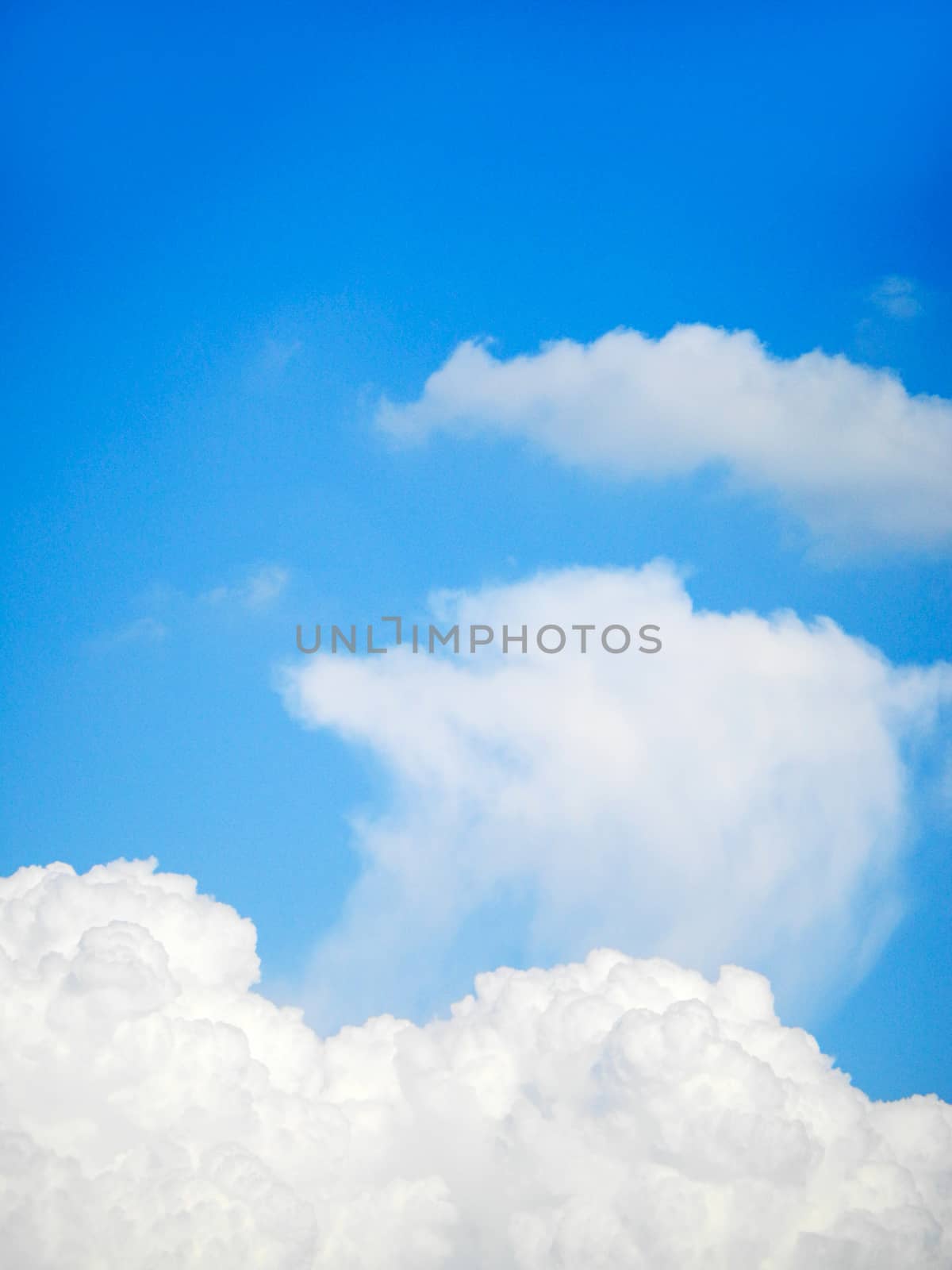 White clouds in blue sky by NuwatPhoto