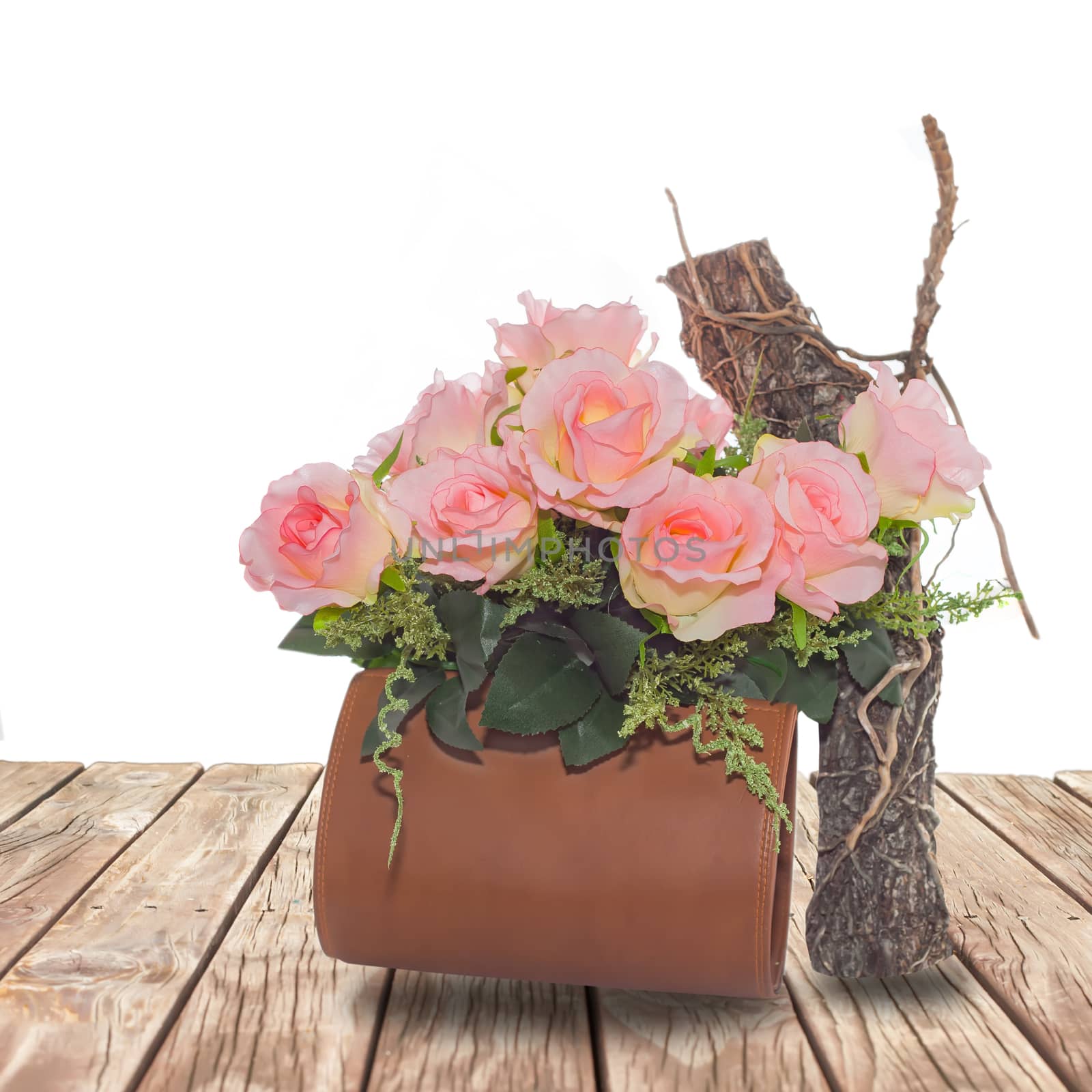 Summer rose flowers in bag on wood walk