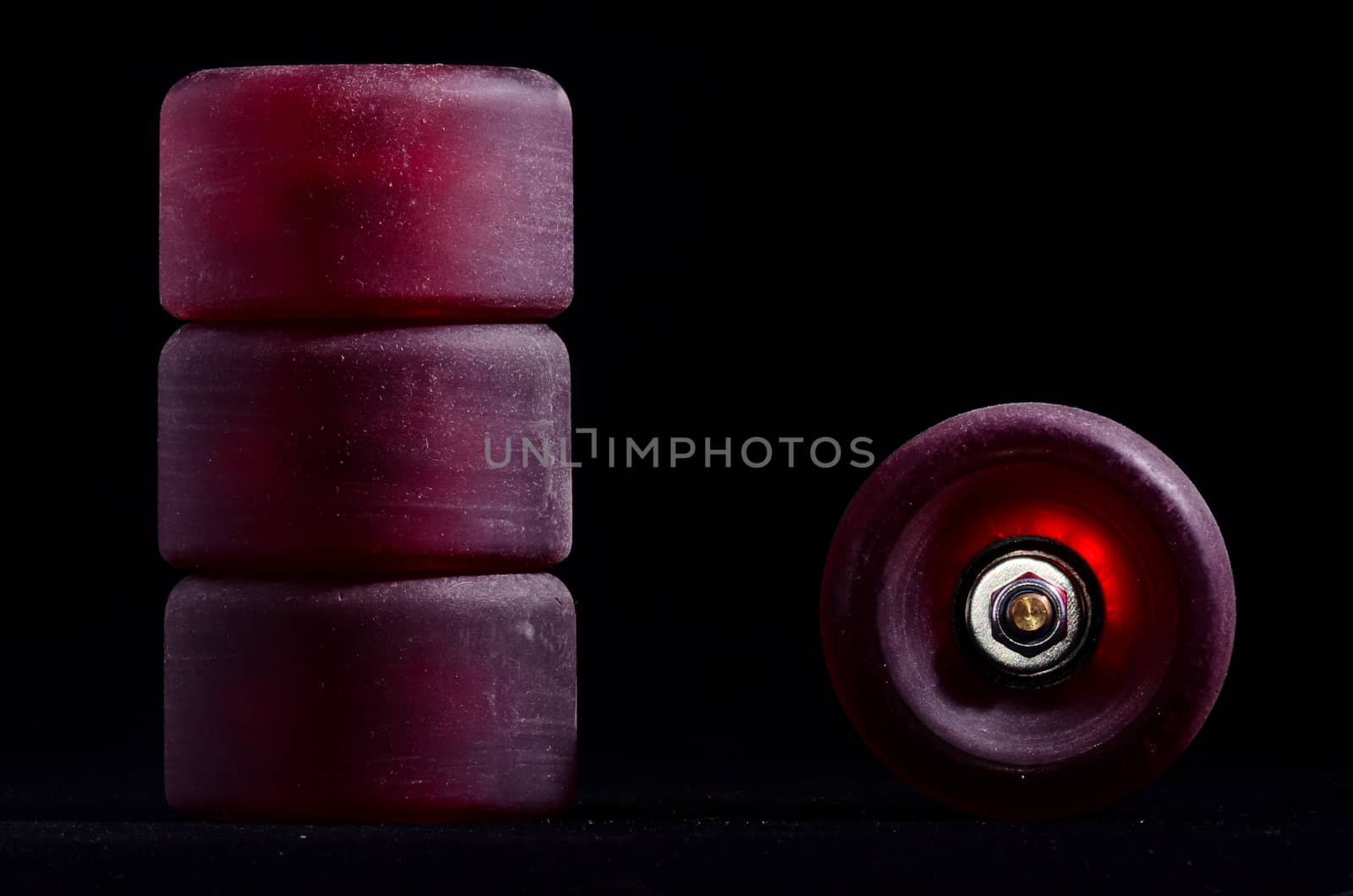 Old Vintage Consumed Skate Wheel on a Black Background