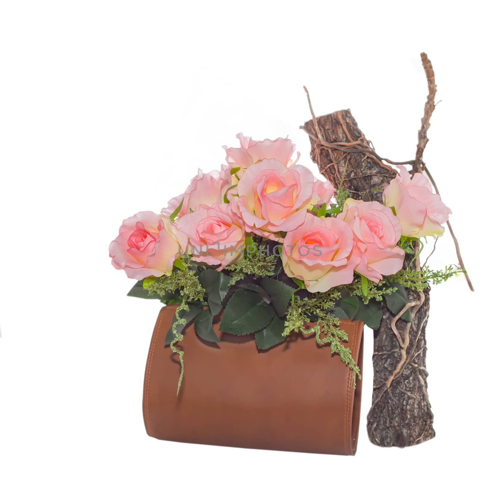flowers in leather bag on white background
