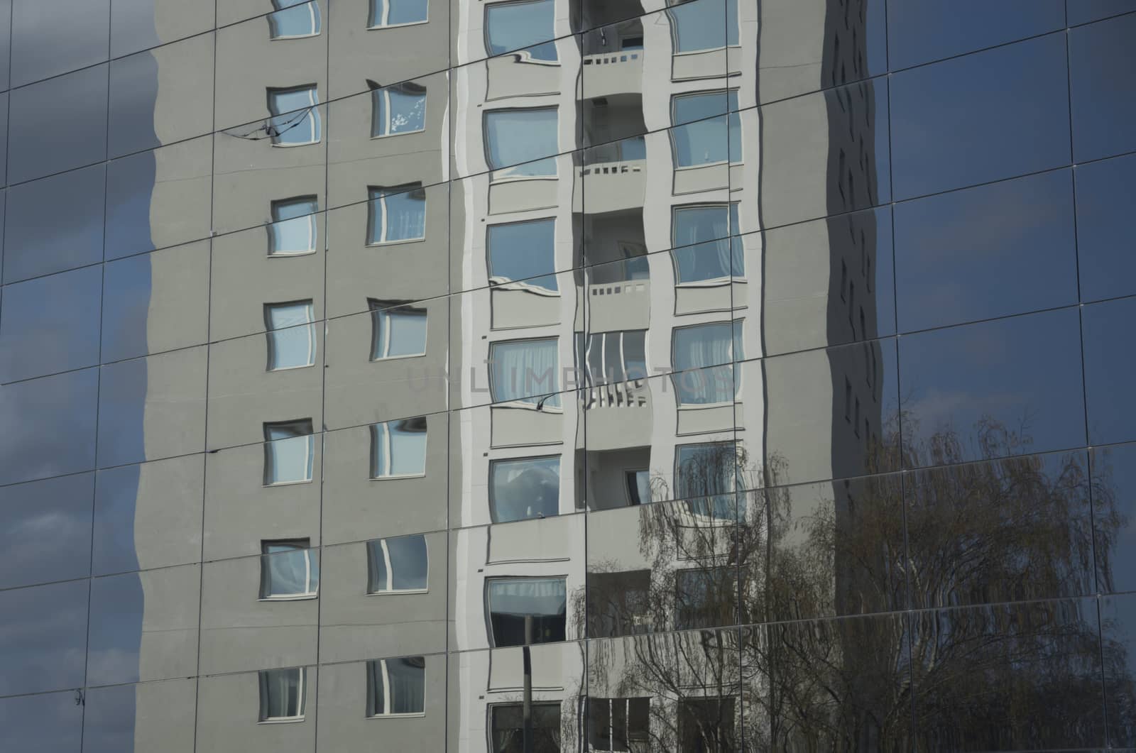 VALLINGBY, STOCKHOLM, SWEDEN ON APRIL 20, 2014: Fifties high rise residential building reflected in new glass architecture on April 20, 2014 in west suburb Vallingby, Stockholm, Sweden.