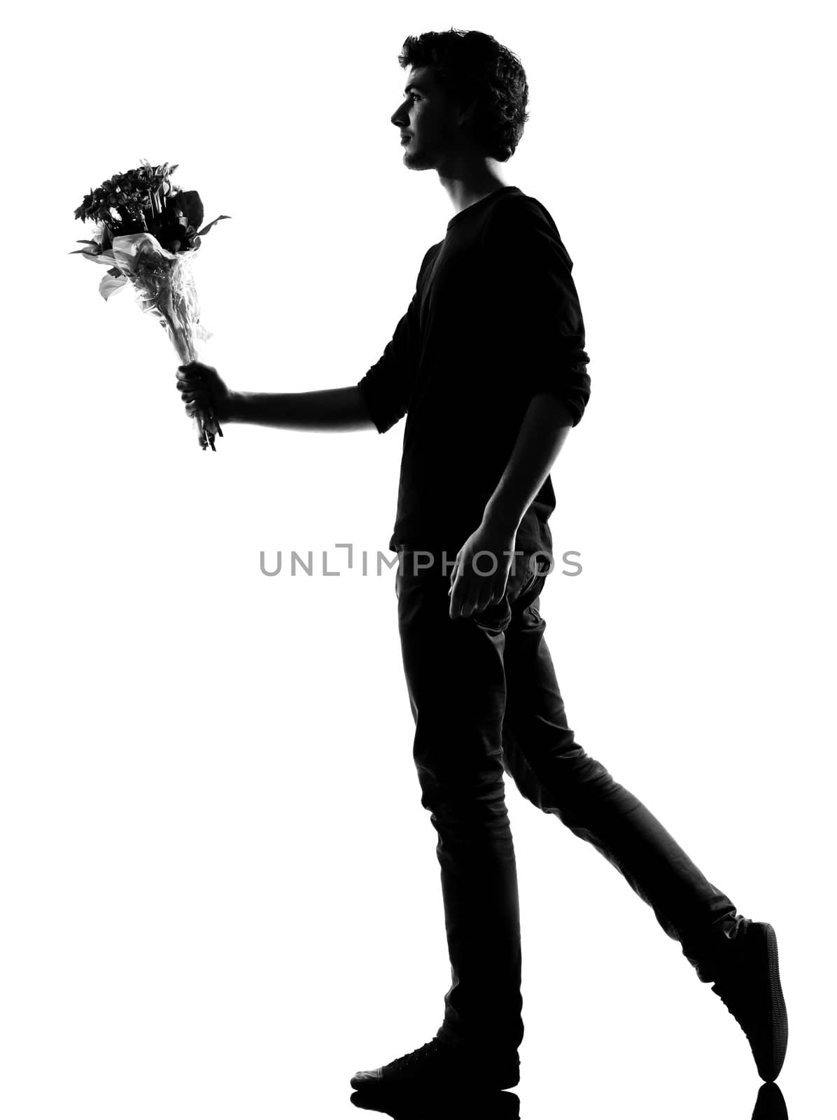 young man offering flowers bouquet silhouette in studio isolated on white background