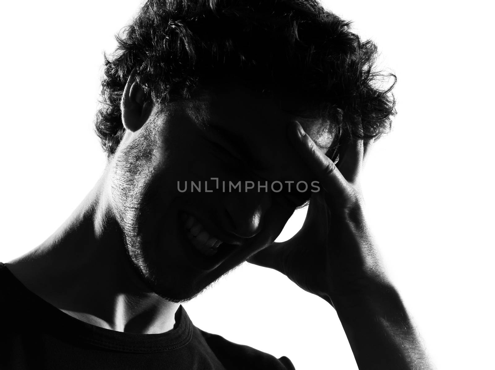 young man headache sadness portrait silhouette in studio isolated on white background
