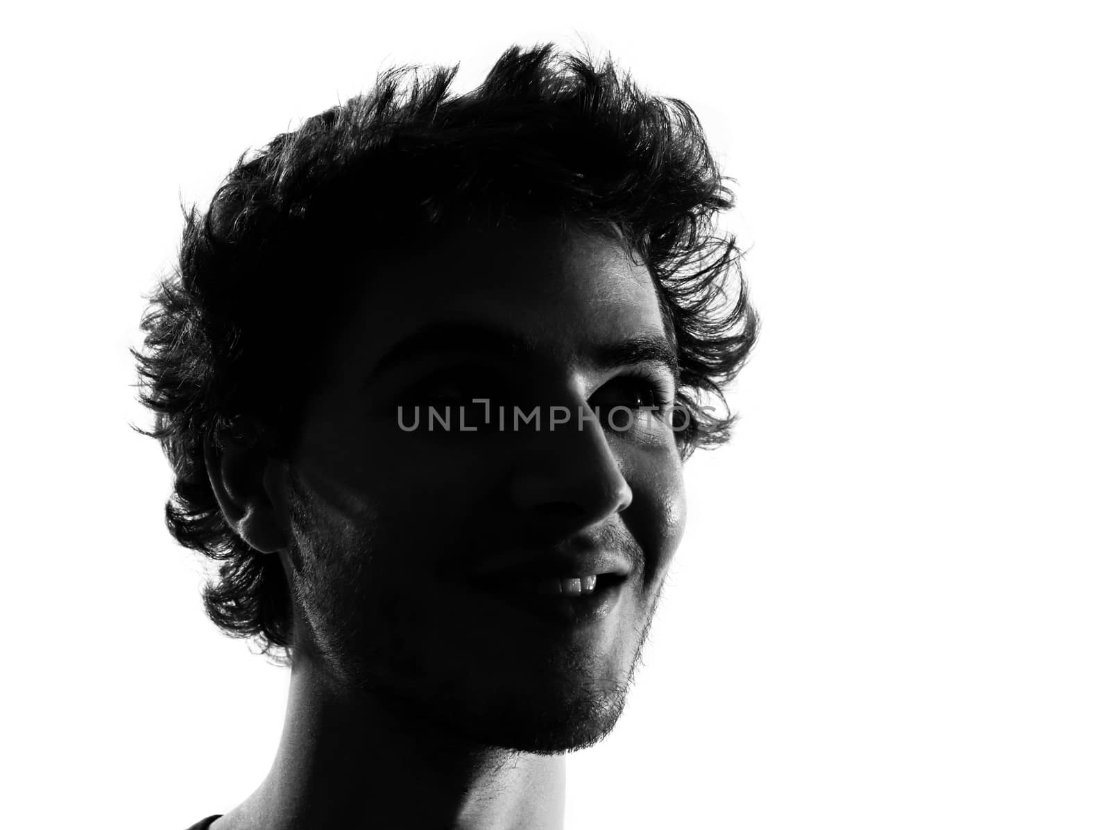 young man looking up portrait silhouette in studio isolated on white background
