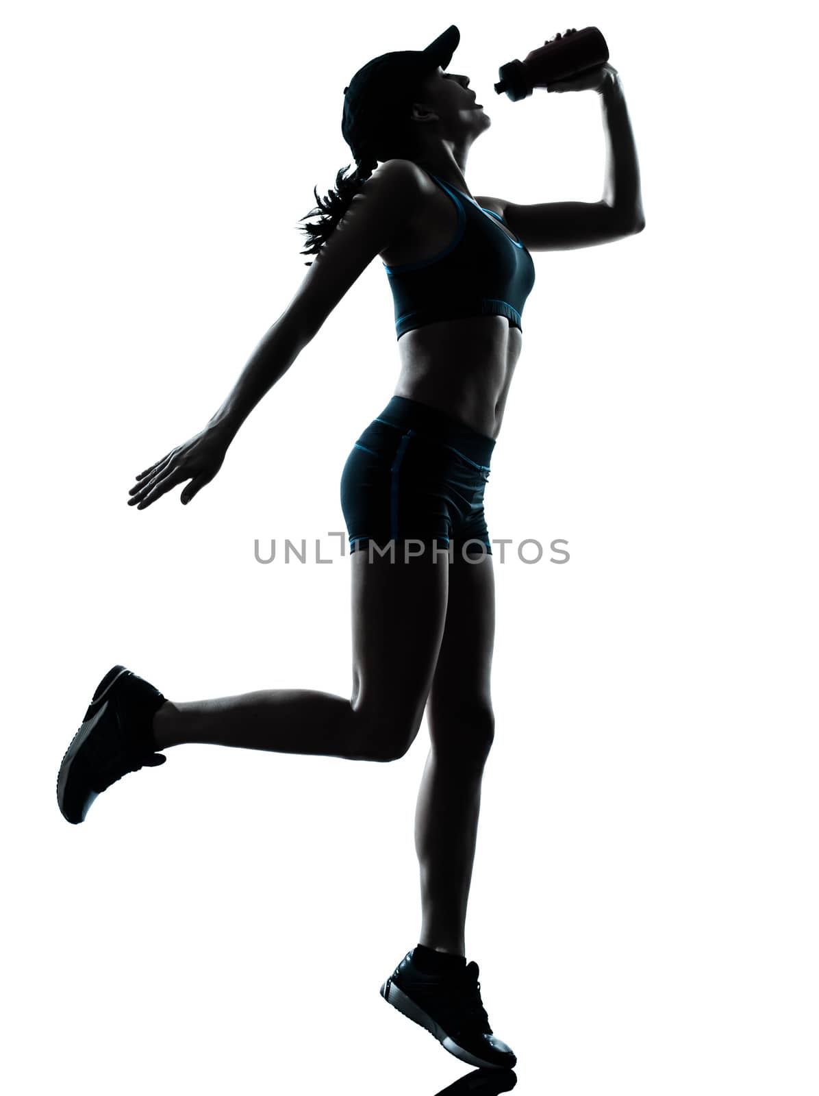 one  woman runner jogger drinking in silhouette studio isolated on white background
