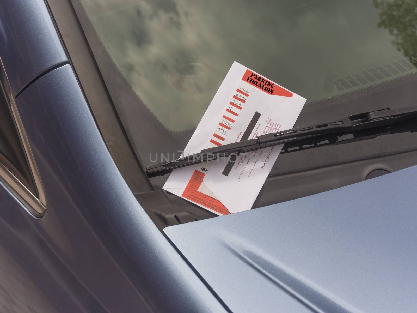 parking ticket violation on motor car windscreen or windshield.