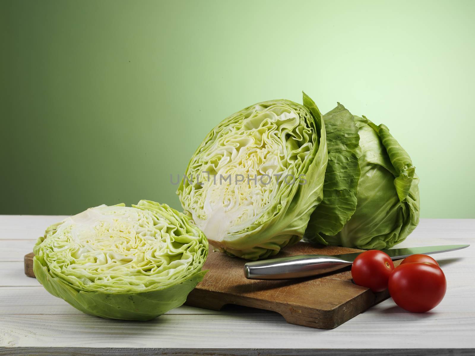 fresh ripe cabbage and tomato on cutting board