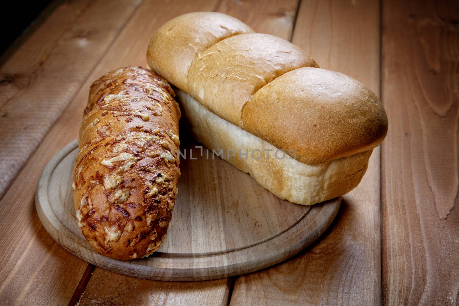 Roll and white loaf on a rural table